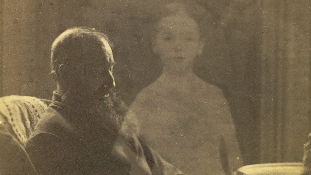 An image claiming to show a ghostly spirit hovering over a seated woman