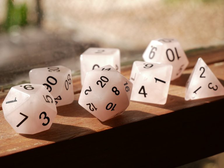 polyhedral dice on wooden surface